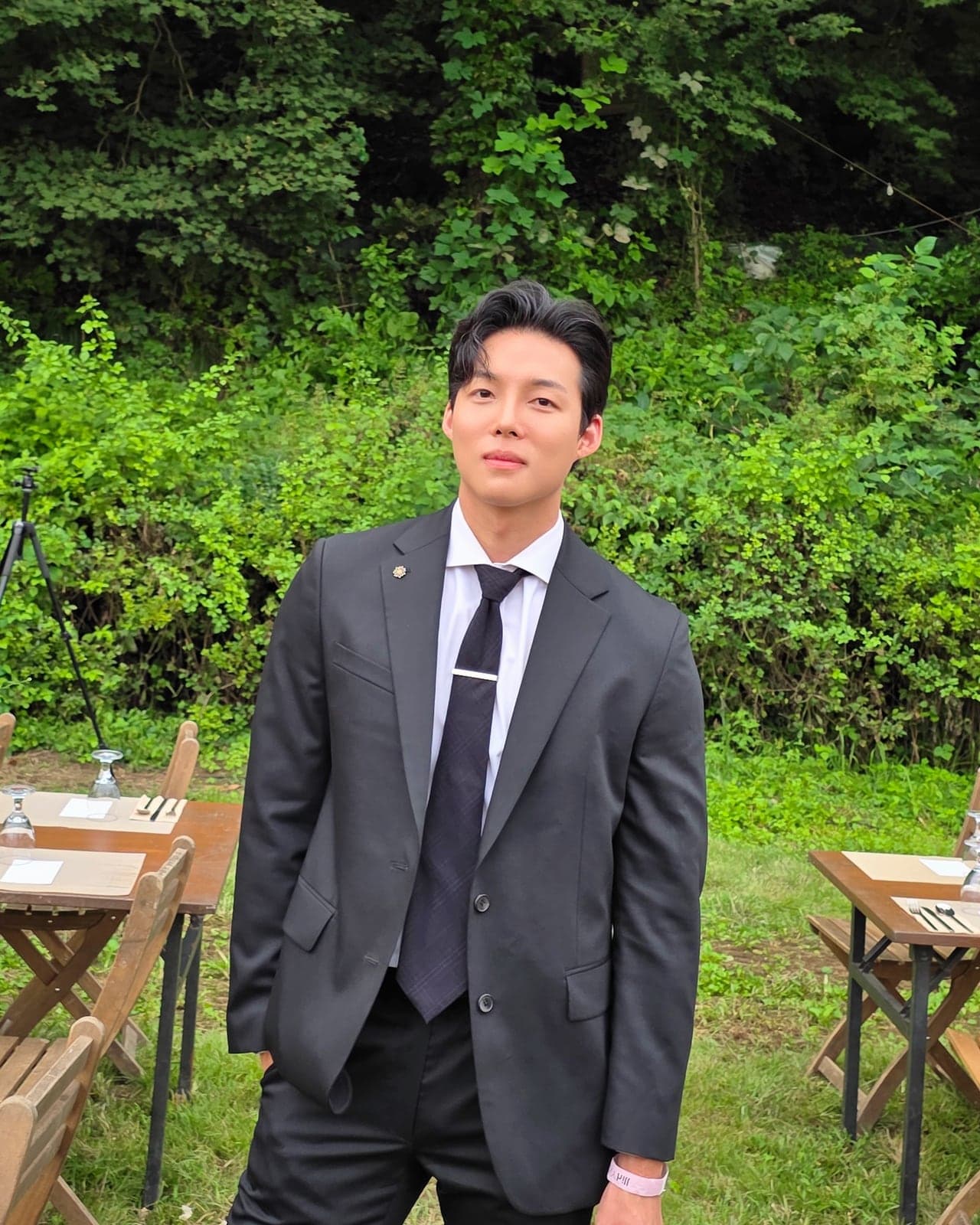 정장을 입고 야외에 서 있는 호스트 승후